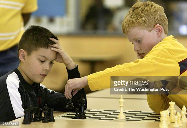 Parks Elementary school's Alex Gonzales watchs as Grace Lutheran's Daniel Scanlan makes a move in their match at the Charles County public schools...