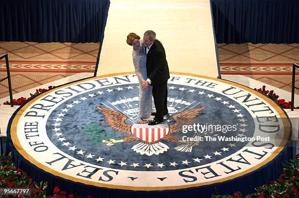 President George W. Bush, and First lady, Laura, dance on the Presidential Seal at the Commander-in-Chief Ball at the National Building Museum.