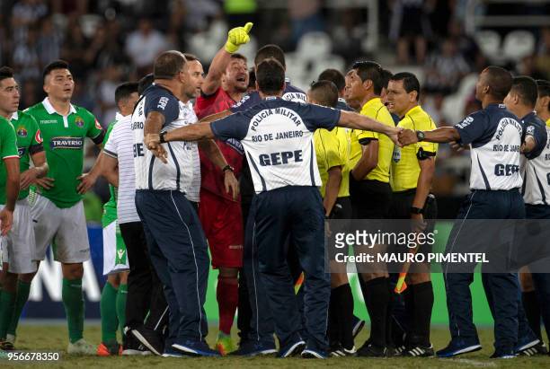 Military police intercede as Chile's Audax Italiano goalkeeper Nicolas Peric complains to Peruvian referee Michael Espinoza after the end of a Copa...
