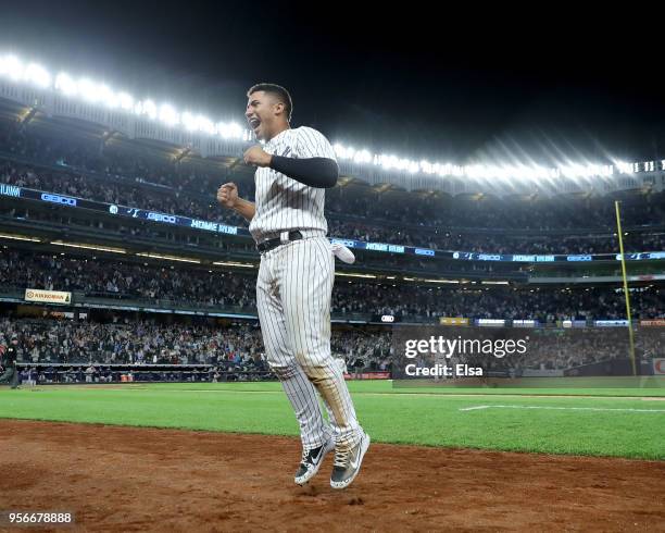 Gleyber Torres of the New York Yankees jumps from the dugout after teamamte Aaron Judge hit a two run home run in the eighth inning against the...