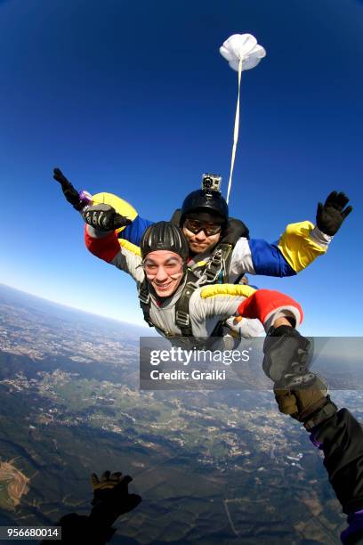 skydiving tandem jump out of plane - skydiving stock pictures, royalty-free photos & images
