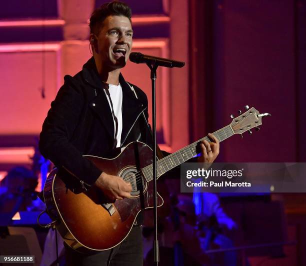 Andy Grammer performs with the Boston Pops Orchestra led by Conductor Keith Lockhart at the orchestra's opening night concert on May 9, 2018 in...