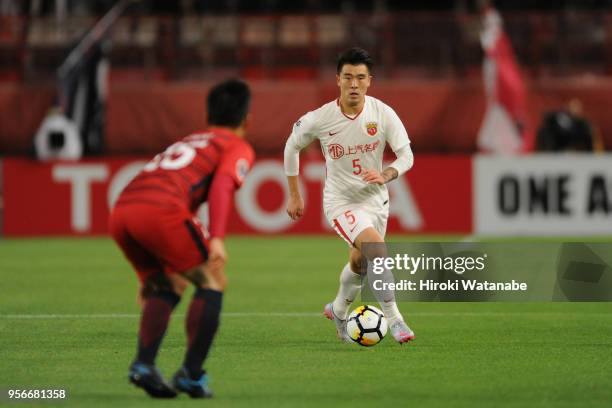 Shi Ke of Shanghai SIPG takes on Yasushi Endo of Kashima Antlers during the AFC Champions League Round of 16 first leg match between Kashima Antlers...