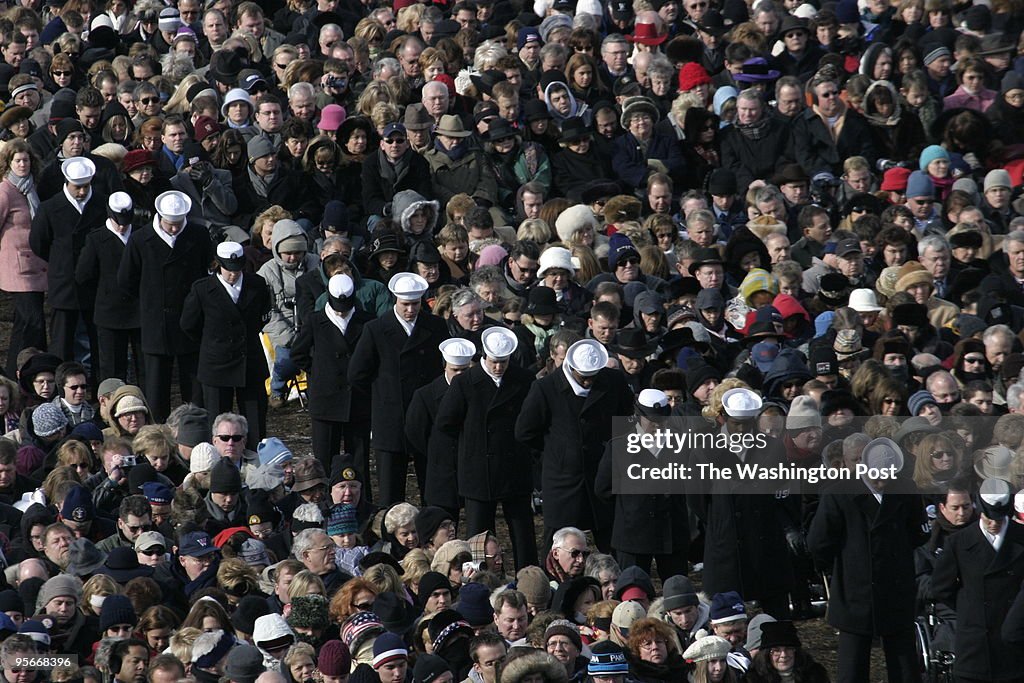 Sailors bow their heads amongst the throngs on the Capitol g