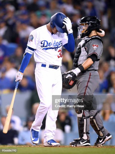 Cody Bellinger of the Los Angeles Dodgers reacts to his strikeout in front of Alex Avila of the Arizona Diamondbacks, with the bases loaded, during...