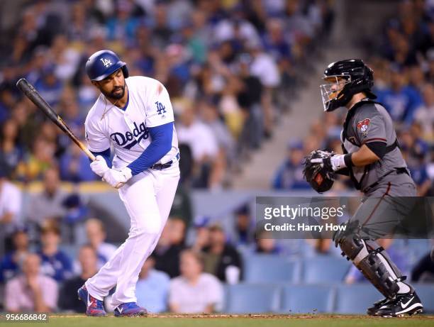 Matt Kemp of the Los Angeles Dodgers reacs to an inside pitch in front of Alex Avila of the Arizona Diamondbacks during the fourth inning at Dodger...