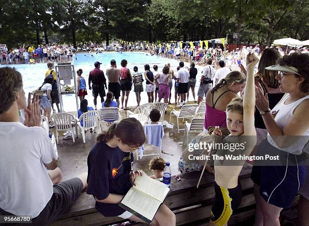 Children read the new book Harry Potter and the Half-Blood Prince during a neighborhood swim meet. Here, oblivious to the surrounding swim meet,...