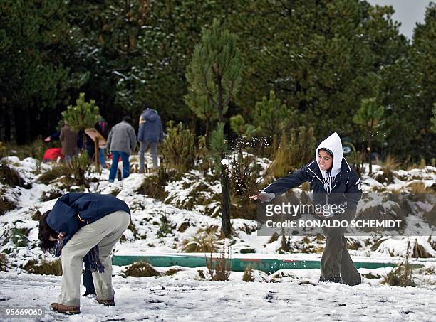 Mexicans play with snow at Paso de Cortes, in the Popocatepetl-Iztaccíhuatl National Park, by the Popocatepetl volcano, in Puebla state, Mexico, on...