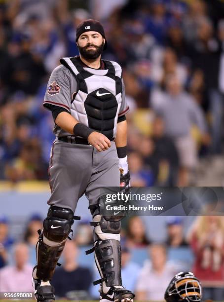 Alex Avila of the Arizona Diamondbacks reacts after a wild pitch to score Yasiel Puig of the Los Angeles Dodgers for a 4-1 Dodger lead during the...