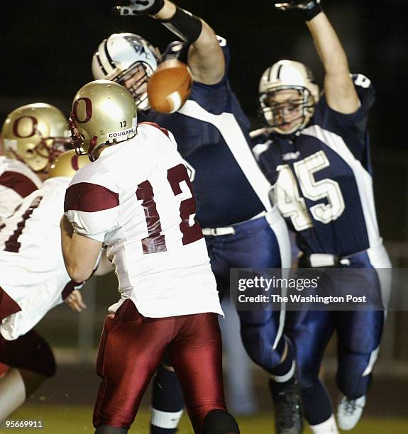 Stone Bridge defensive lineman Andrew Nuss knocks down the attempted pass of Oakton's QB Stephen Pourmaras during 1st quarter action.