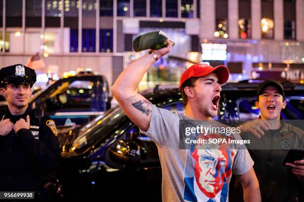 Donald Trump supporter roars in triumph on 6th Avenue in Midtown Manhattan in the early hours after Election Day as news breaks that Hillary Clinton...