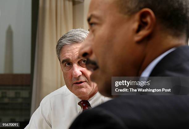 Robert S. Mueller III, FBI director, looks at Executive Assistant Director-Criminal Division, Michael Mason during a meeting in Mueller's office...