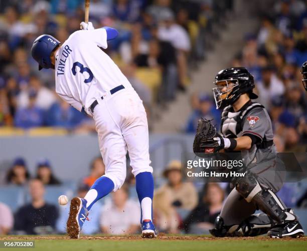 Chris Taylor of the Los Angeles Dodgers is hit by a pitch in front of Alex Avila of the Arizona Diamondbacks, scoring Austin Barnes with the bases...