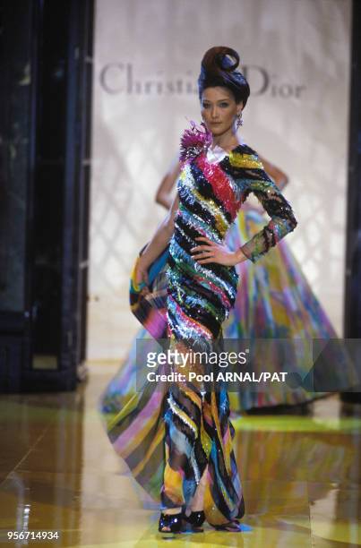 Carla Bruni porte une robe fourreau rayée pailletée multicolore lors du défilé Dior Haute Couture Printemps/Eté en janvier 1995 à Paris, France.