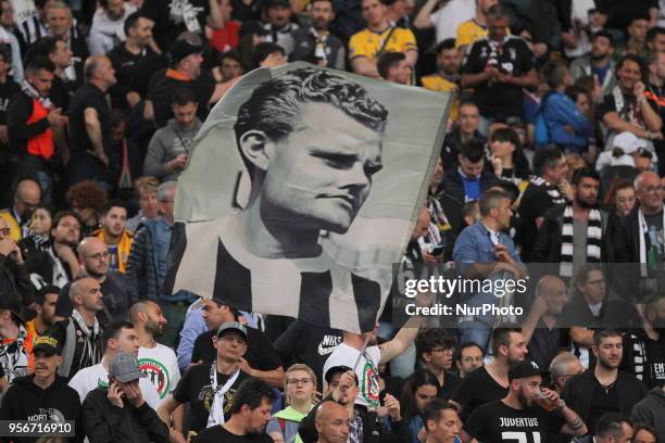 Juventus fan waves a flag with the face of Juventus legend Giampiero Boniperti before the Italian Cup final match between Juventus FC and AC Milan at...