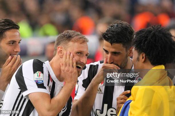 Rodrigo Bentancur , Benedikt Hwedes , Sami Khedira and Juan Cuadrado celebrates the Italian Cup win after the final match against Milan at Stadio...