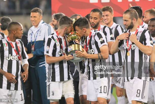 Miralem Pjanic and Paulo Dybala lifts the Italian Cup trophy after the final match between Juventus FC and SS Lazio at the Stadio Olimpico on May 09,...