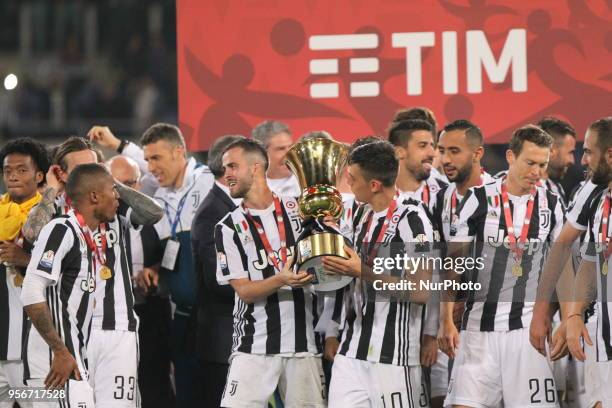 Miralem Pjanic and Paulo Dybala lifts the Italian Cup trophy after the final match between Juventus FC and SS Lazio at the Stadio Olimpico on May 09,...