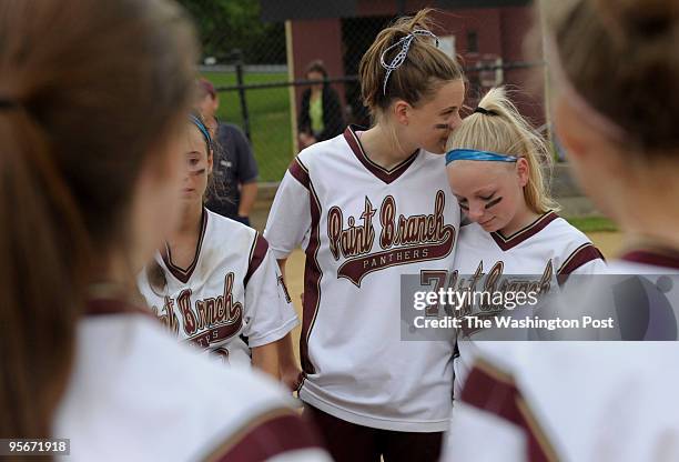 Paint Branch High School junior Cathleen Carey, left, consoles her teammate and friend senior Mindy Miller, right, after losing to Urbana High School...