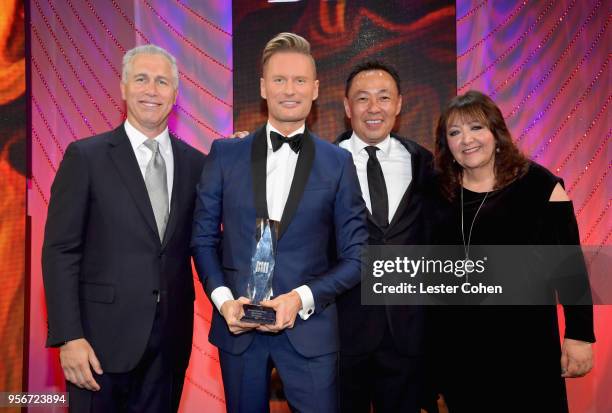 Brian Tyler accepts award from BMI Vice President, Creative - Film, TV & Visual Media Doreen Ringer Ross, Executive Vice President of Creative &...