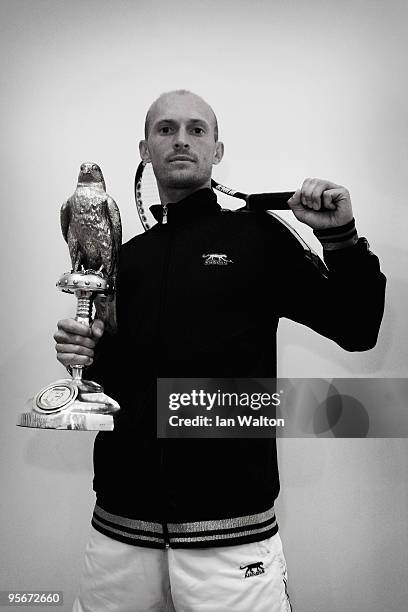 Nikolay Davydenko of Russia celebrates with the trophy after winning against Rafael Nadal of Spain in the Final match of the ATP Qatar ExxonMobil...