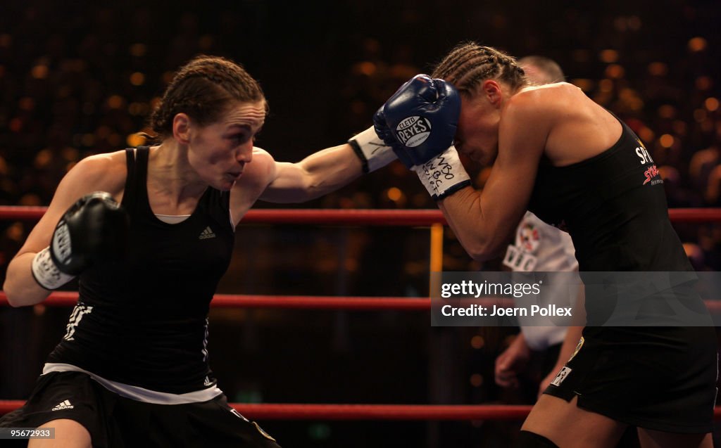 Boxing Ina Ina Menzer of Germany exchanges punches with Ramona Kuehne of Germany ...