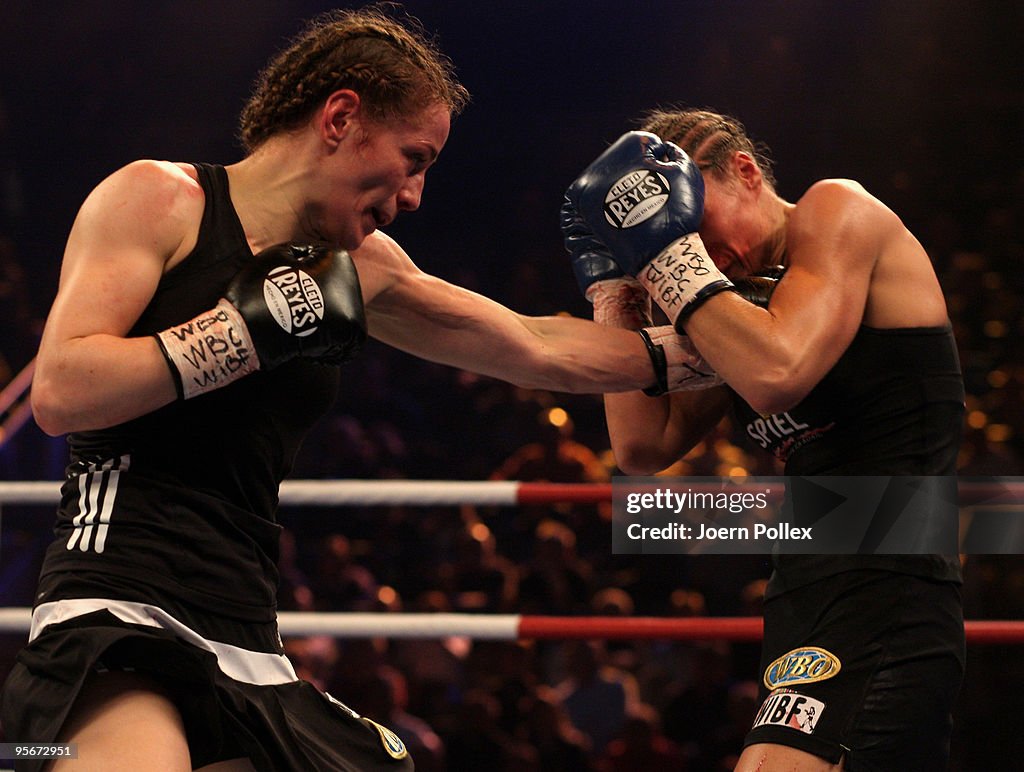 Boxing Ina Ina Menzer of Germany exchanges punches with Ramona Kuehne of Germany ...
