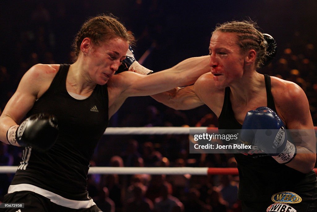 Boxing Ina Ina Menzer of Germany exchanges punches with Ramona Kuehne of Germany ...