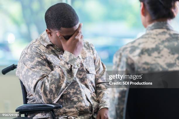 upset injured soldier in therapy session - injured us army stock pictures, royalty-free photos & images