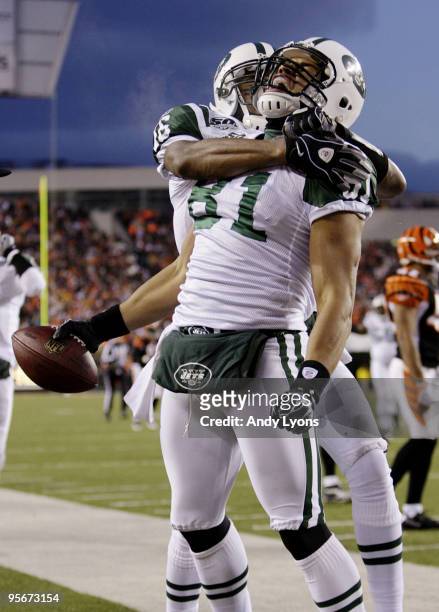 Tight end Dustin Keller of the New York Jets celebrates a 45-yard touchdown with teammate Brad Smith during the 2010 AFC wild-card playoff game...