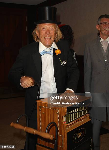 Rolf Eden plays a barrel organ at the 111. Berlin Press ball at Maritim Hotel on January 9, 2010 in Berlin, Germany.