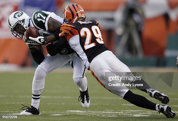 Wide receiver Braylon Edwards of the New York Jets is tackled by cornerback Leon Hall of the Cincinnati Bengals after a catch during the 2010 AFC...