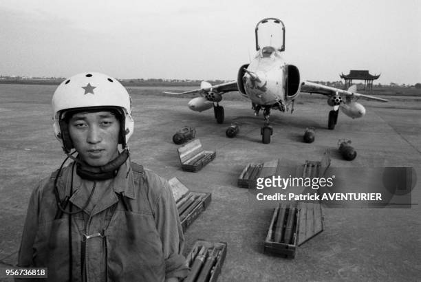 Pilote posant devant son avion de chasse Mig-19 avec son armement sur la base aérienne de Hanzhou en novembre 1988, Chine.