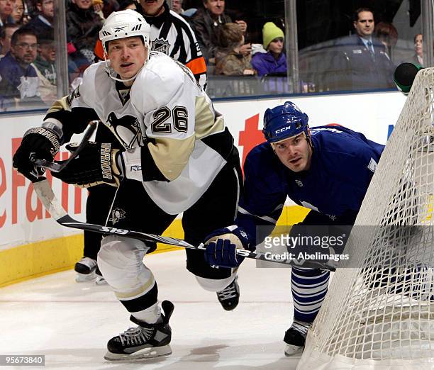 Ian White of the Toronto Maple Leafs gets hit by Ruslan Fedotenko of the Pittsburgh Penguins during game action January 9, 2010 at the Air Canada...