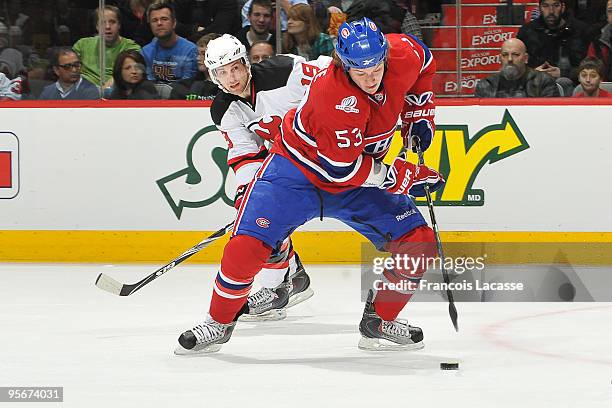 Ryan White of Montreal Canadiens skates with the puck in front of Travis Zajac of New Jersey Devils during the NHL game on January 9, 2010 at the...