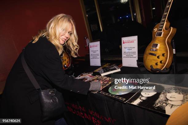 Musician Nancy Wilson of Heart signs an autograph after rehearsal for the Musicares Concert for Recovery at the Showbox on May 9, 2018 in Seattle,...