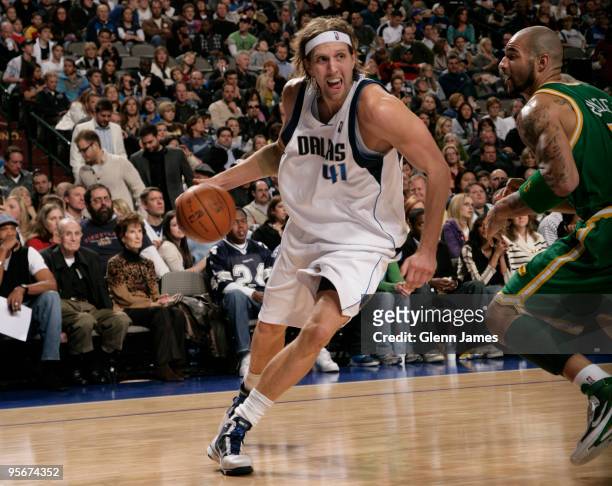 Dirk Nowitzki of the Dallas Mavericks drives against Carlos Boozer of the Utah Jazz during a game at the American Airlines Center on January 9, 2010...