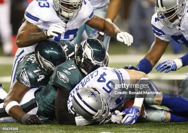 Linebacker Bobby Carpenter of the Dallas Cowboys recovers a fumble by quarterback Michael Vick of the Philadelphia Eagles during the 2010 NFC...