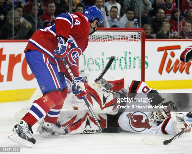 Martin Brodeur of the New Jersey Devils stops the puck on a shot by Roman Hamrlik of the Montreal Canadiens during the NHL game on January 9, 2010 at...