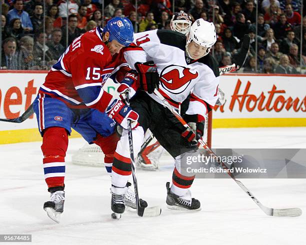 Glen Metropolit of the Montreal Canadiens and Dean McAmmond of the New Jersey Devils battle for the puck during the NHL game on January 9, 2010 at...