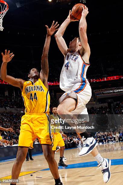 Nick Collison of the Oklahoma City Thunder goes to the basket against Solomon Jones of the Indiana Pacers on January 9, 2010 at the Ford Center in...