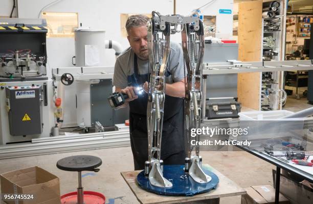Engineered Arts prosthetic expert Mike Humphrey works on legs for robots being built at the company's headquarters in Penryn on May 9, 2018 in...