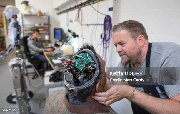 Engineered Arts prosthetic expert Mike Humphrey checks on Fred a recently completed Mesmer robot that was built at the company's headquarters in...