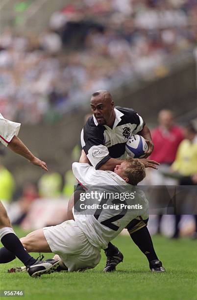 Jonah Lomu of Barbarians is tackled by Josh Lewsey of England during the Scottish Amicable Tour Match between England and The Barbarians played at...