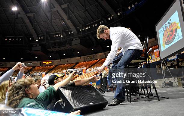 Dale Earnhardt Jr., driver of the National Guard/Amp Energy Chevrolet, signs autographs before a Q&A session during the fifth annual Sprint Sound and...