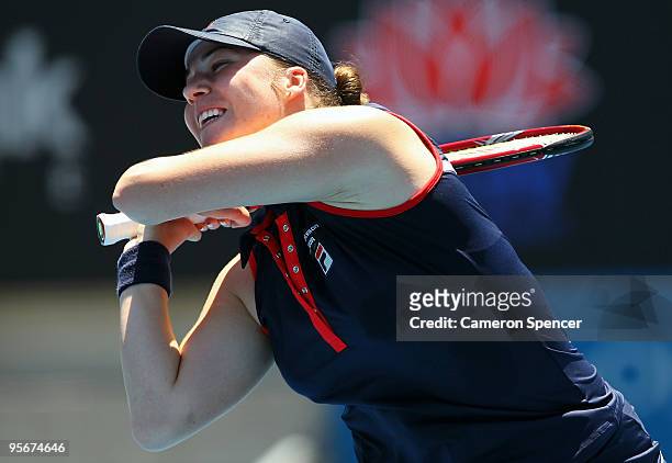 Alisa Kleybanova of Russia plays a backhand in her first round match against Svetlana Kuznetsova of Russia during day one of the 2010 Medibank...