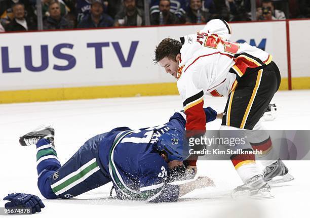 Brandon Prust of the Calgary Flames winds up to throw a punch at Rick Rypien of the Vancouver Canucks during a fight in their game at General Motors...