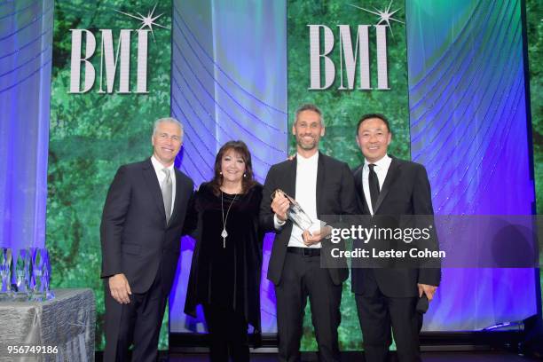 Rob Simonsen accepts award from BMI Vice President, Creative - Film, TV & Visual Media Doreen Ringer Ross, Executive Vice President of Creative &...