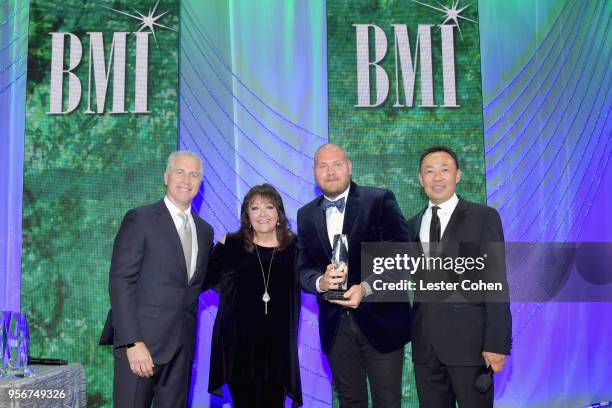 Dominic Lewis accepts award from BMI Vice President, Creative - Film, TV & Visual Media Doreen Ringer Ross, Executive Vice President of Creative &...