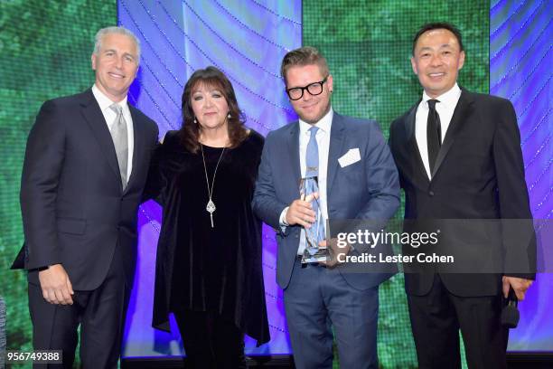 Jeremiah Zimmerman accepts award from BMI Vice President, Creative - Film, TV & Visual Media Doreen Ringer Ross, Executive Vice President of Creative...